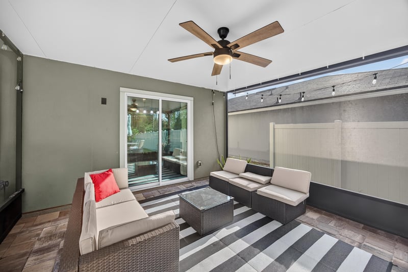 Screened porch with outdoor seating at 65255 Frst Glen Ln, Yulee, FL 32097