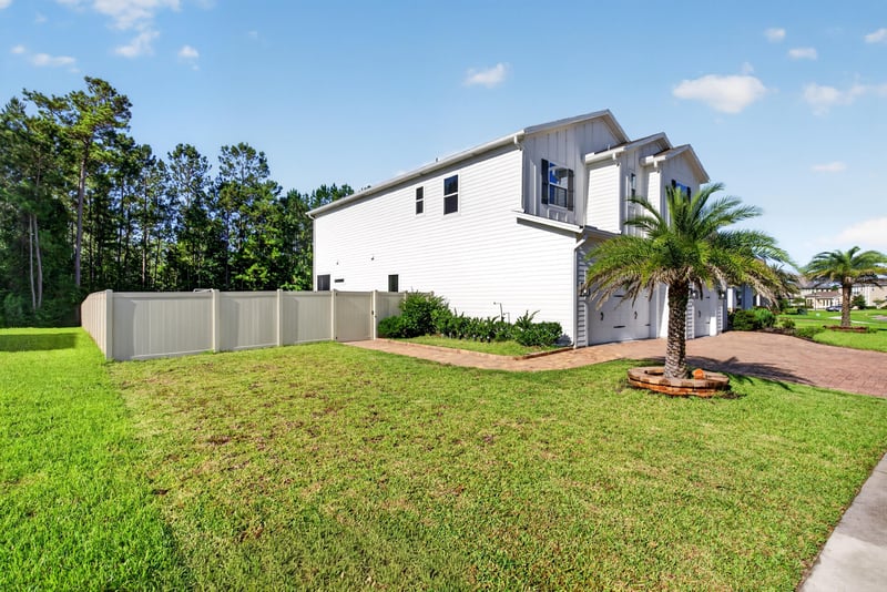 Wide front exterior view with side yard at 22 Azura Point