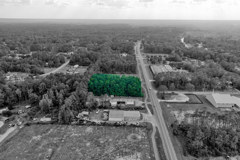 Black and white aerial of the wooded parcel and surrounding fields at 4393 Co Rd 218, Middleburg, FL 32068