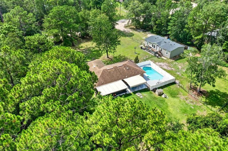 Distant aerial view of the home and pool in Middleburg, FL