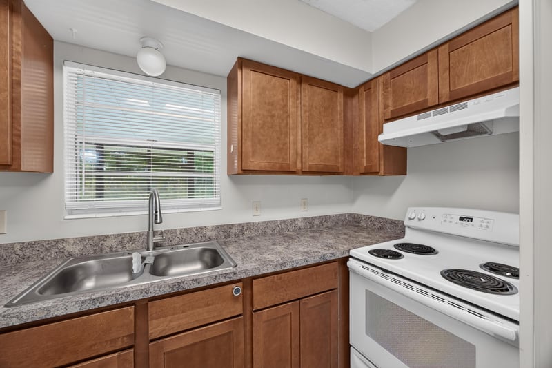 Kitchen sink with granite-look counters and window at 12351 Condor Dr