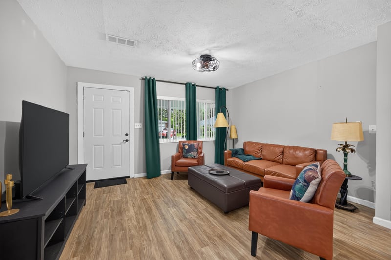 Living room with television and leather seating at 9506 Harriet Ave, Jacksonville, FL 32208
