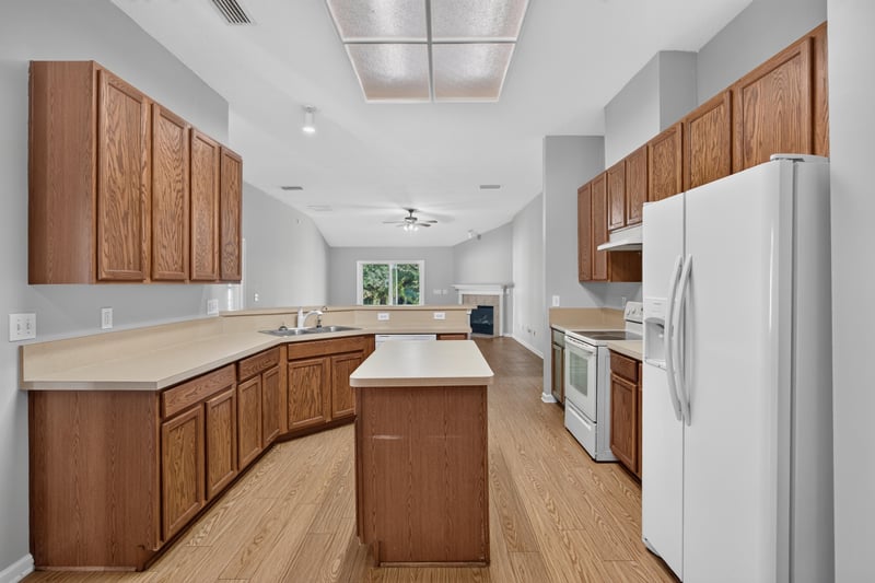 Kitchen with island and white refrigerator at 14147 Fish Eagle Dr E, Jacksonville, FL 32226