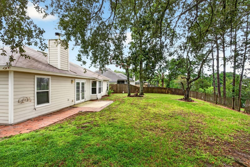 Backyard with trees and open lawn at 12949 Chets Creek Dr S, Jacksonville, FL 32224