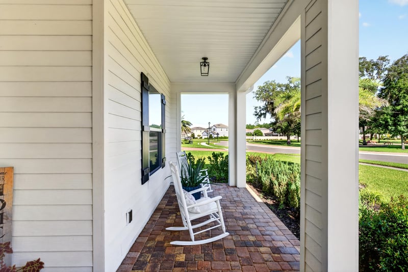 Wraparound front porch with rocking chair at 22 Azura Point