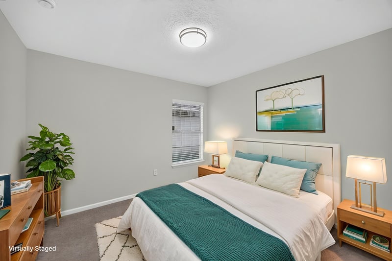 Virtually staged bedroom with bed and TV stand at 706 Bonaparte Dr, Jacksonville, FL 32218