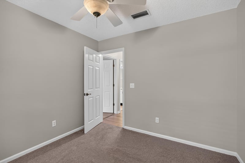 Empty room with carpet and door at 1955 GUARDED Way, Fleming Island, FL 32003