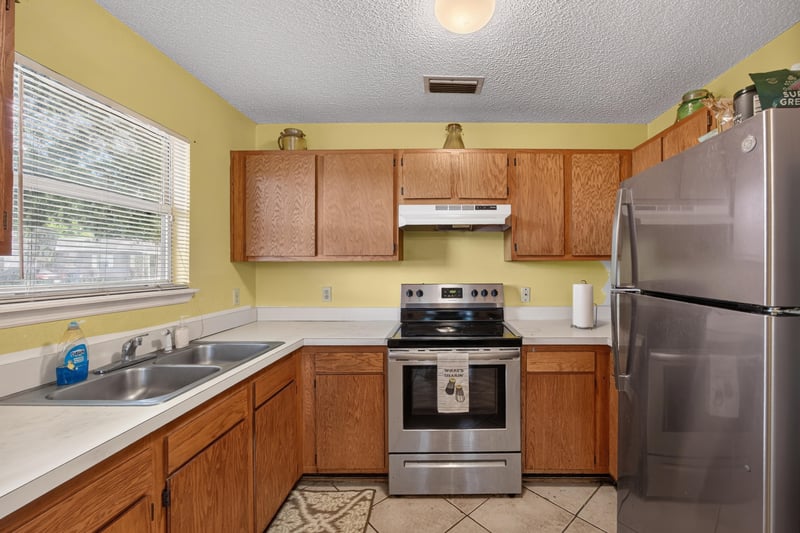 Kitchen with stainless refrigerator and window at 5375 Dodge Rd, Jacksonville, FL 32209
