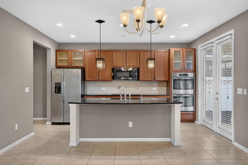 Kitchen with stainless refrigerator and French doors to yard at 263 Gilmore Ln, Orange Park, FL 32065