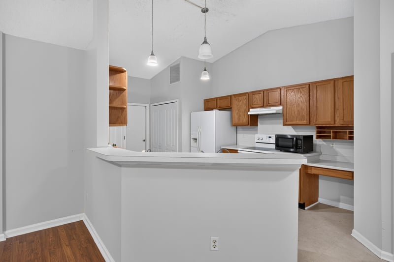 Kitchen with breakfast bar and open shelving at 9691 Nelson Forks Dr, Jacksonville, FL 32222