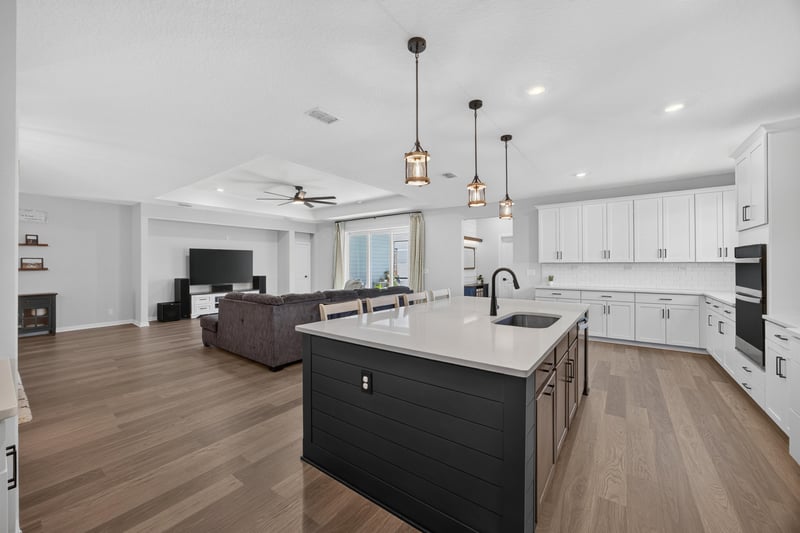 Kitchen open to living room with pendant lights at 2354 Jennings Farm Dr, Middleburg, FL 32068