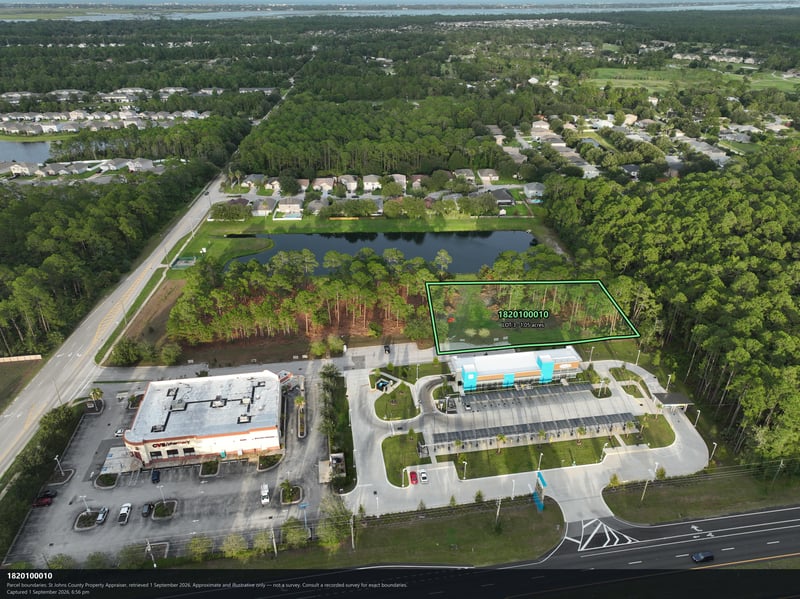 Aerial view of the pond and commercial building with parking at 4900 US-1, St. Augustine, FL 32086