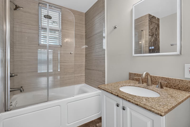 Bathroom with tub-shower combo and granite vanity at 217 Baisden Rd, Jacksonville, FL 32218