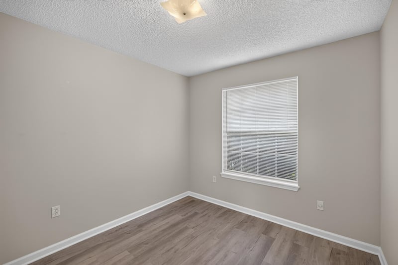 Bedroom with window and wood floor at 8519 Blazing Star Ct, Jacksonville, FL 32210