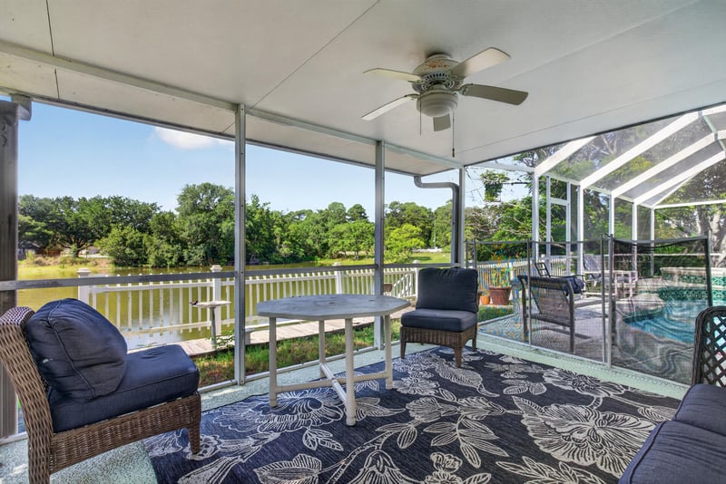 Covered patio with ceiling fan and seating at 8680 Bandera Cir S, Jacksonville, FL 32244