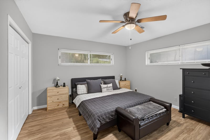 Bedroom with ceiling fan and wood-look flooring at 9506 Harriet Ave, Jacksonville, FL 32208