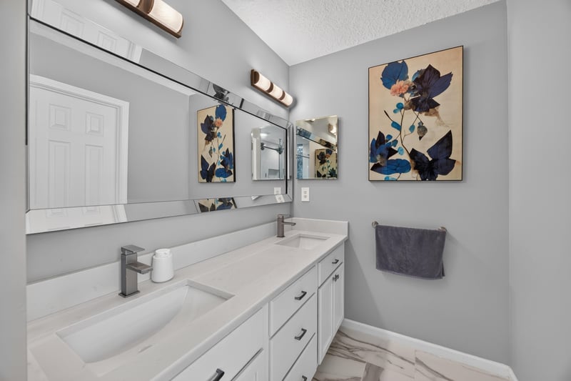Primary bathroom with double vanity and mirror at 12825 Kelsey Island Dr, Jacksonville, FL 32224