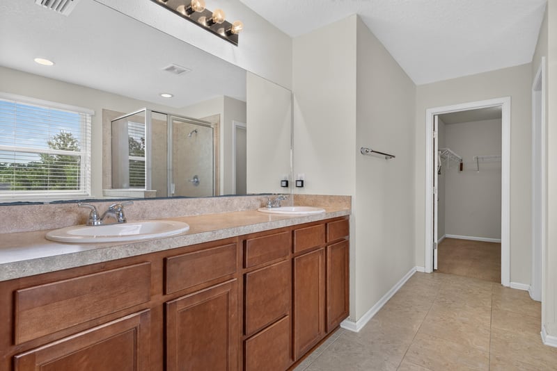 Primary bathroom with double vanity and granite counters at 263 Gilmore Ln, Orange Park, FL 32065