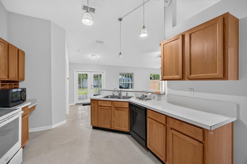 Kitchen with oak cabinets and dishwasher at 9691 Nelson Forks Dr, Jacksonville, FL 32222