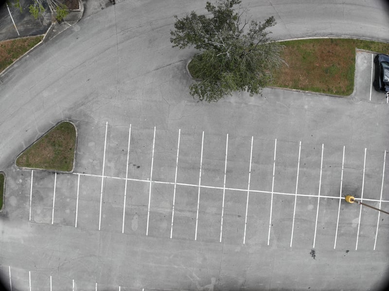 Aerial view of empty parking rows and landscaped corner at 9406 Atlantic Blvd, Jacksonville, FL 32225