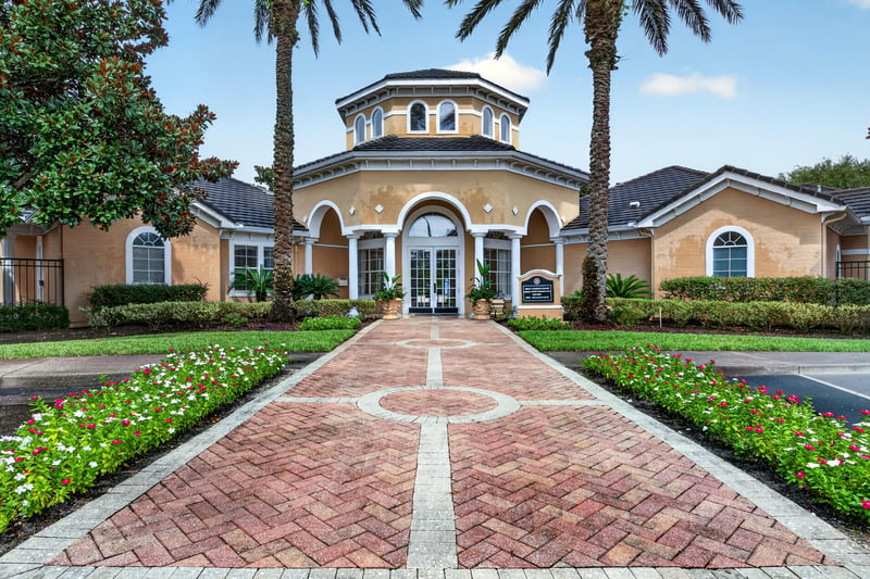 Clubhouse exterior with fountain and palm trees in Mirabella Condo