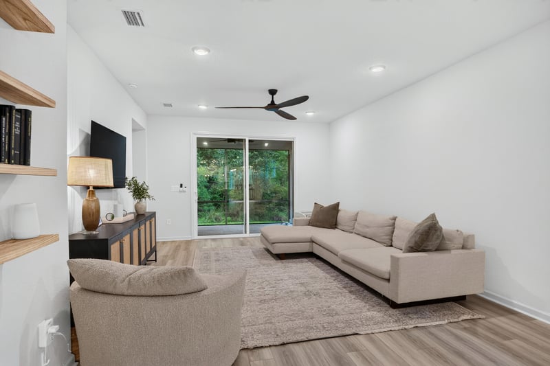 Living room with sectional sofa and shelving at 93 Lochloosa Ct, St. Johns, FL 32259
