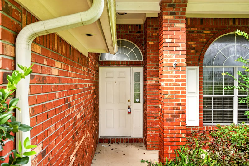 Front entry with brick archway and door at 11669 Collins Creek Dr, Jacksonville, FL 32258
