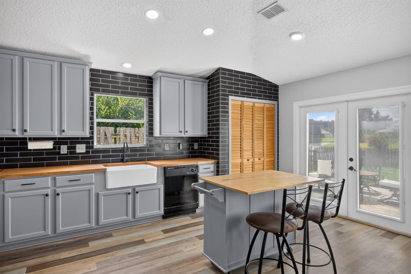 Kitchen with black subway tile backsplash at 2065 Creekmont Dr