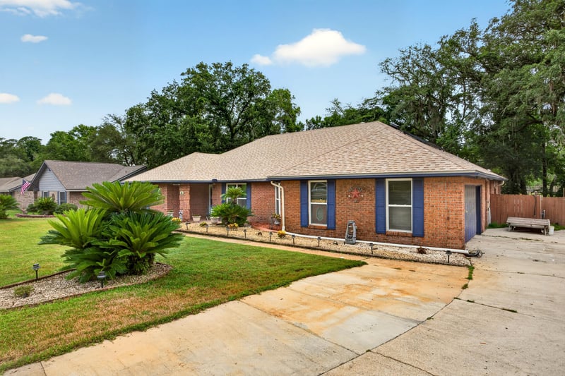 Front exterior with palm landscaping and driveway at 981 Marble Ridge Dr, Orange Park, FL 32065