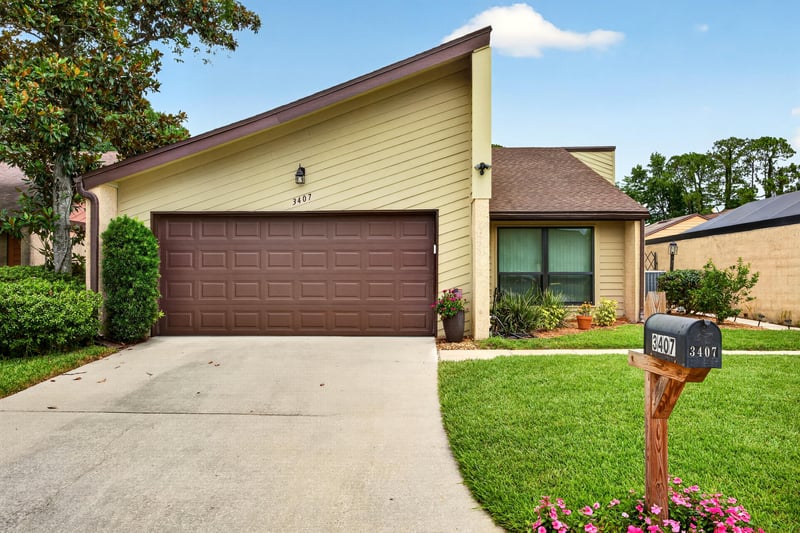 Front exterior with garage and mailbox at 3407 Fairbanks Grant Rd N, Jacksonville, FL 32223