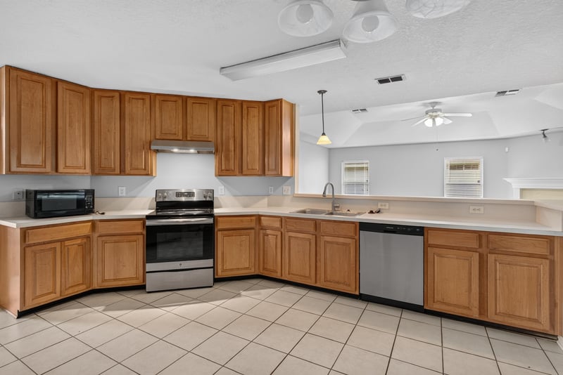 Kitchen with wood cabinets and tile floor at 11669 Collins Creek Dr, Jacksonville, FL 32258