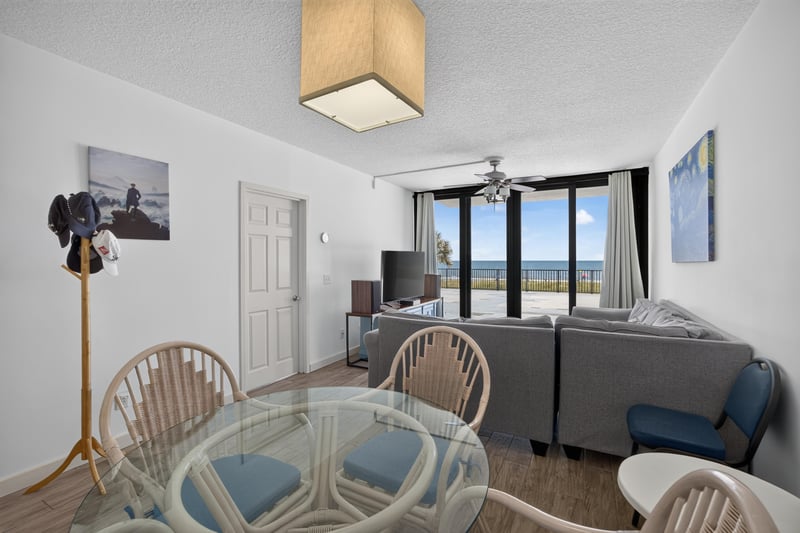 Living room with ceiling fan and dining table at 601 1st St S, Jacksonville Beach