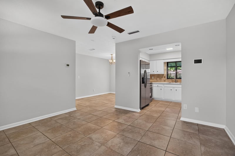 Open room leading toward kitchen with tile flooring at 7453 Jade Dr N, Jacksonville, FL 32210