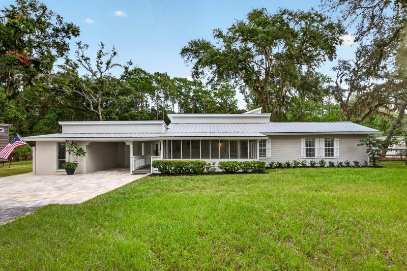 Front exterior with screened porch and driveway at 1161 Whispering Pines Rd, Jacksonville, FL 32259