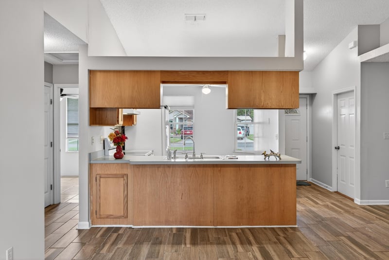 Kitchen with breakfast bar and wood cabinets at 2164 Orangewood St, Middleburg, FL 32068
