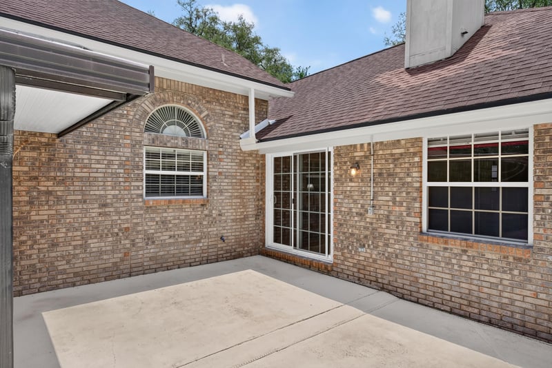 Backyard patio with brick exterior at 12810 Swamp Owl Ln