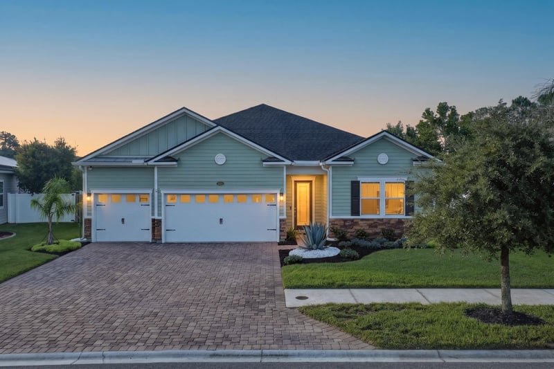 Front exterior at day-to-dusk with paver driveway at 3328 Southern Oaks Dr, Green Cove Springs, FL 32043