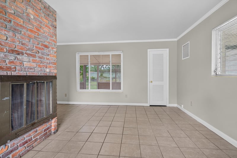 Living room with brick fireplace at 2618 Arlex Dr E, Jacksonville, FL
