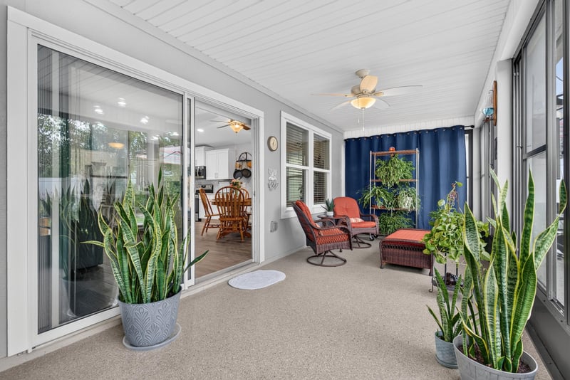 Screened lanai with wicker furniture at 4319 Green River Pl, Middleburg, FL 32068