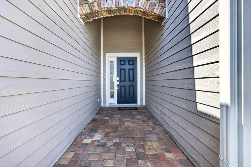 Covered entry walkway leading to front door at 9942 Lovage Ln, Jacksonville, FL 32219