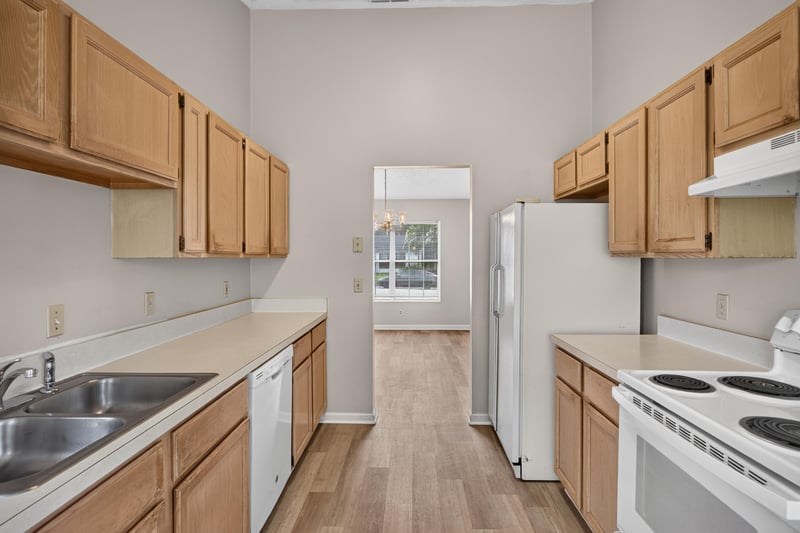 Kitchen with wood cabinets and double sink at 6646 Shiloh Creek Dr