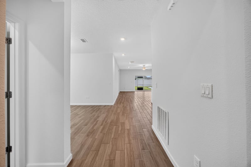 Entry hallway with wood-look flooring at 9905 Ansley Lake Dr, Jacksonville, FL