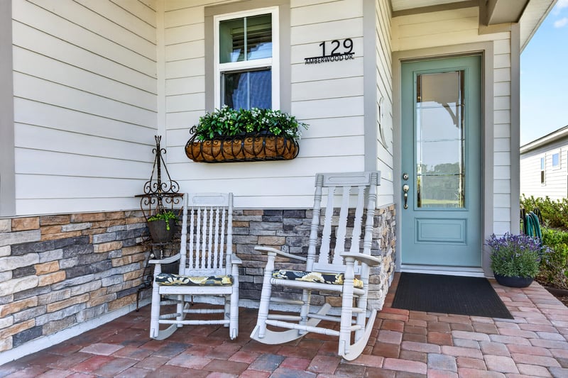 Front porch with rocking chairs and house number at 129 Amberwood Dr, St. Augustine, FL