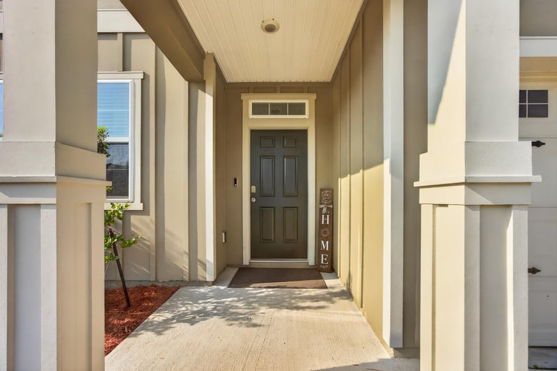 Covered front entry with door and columns at 65255 Frst Glen Ln, Yulee, FL 32097