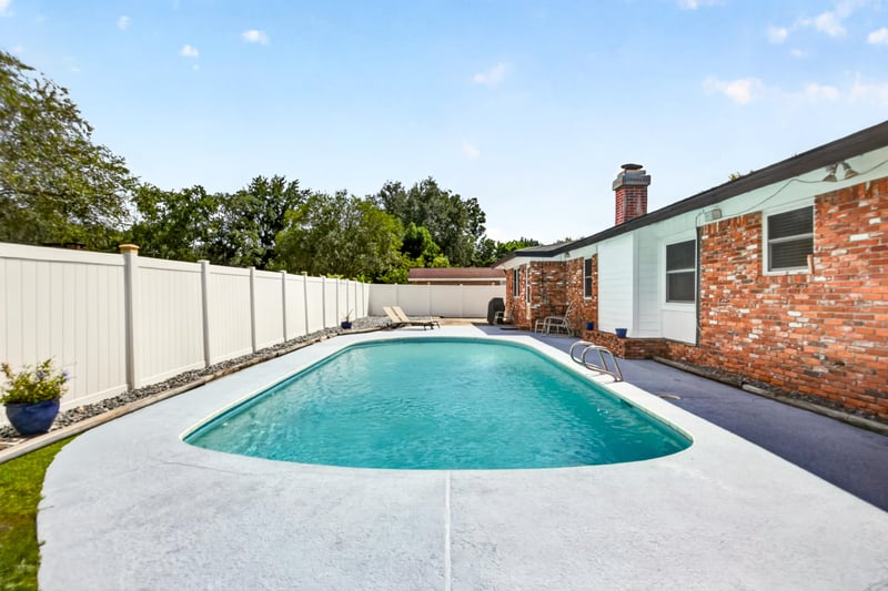 Backyard pool view along fence line at 6059 Karen St, Jacksonville, FL 32244