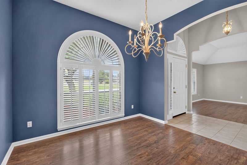 Empty room with chandelier and arched window at 1955 GUARDED Way, Fleming Island, FL 32003