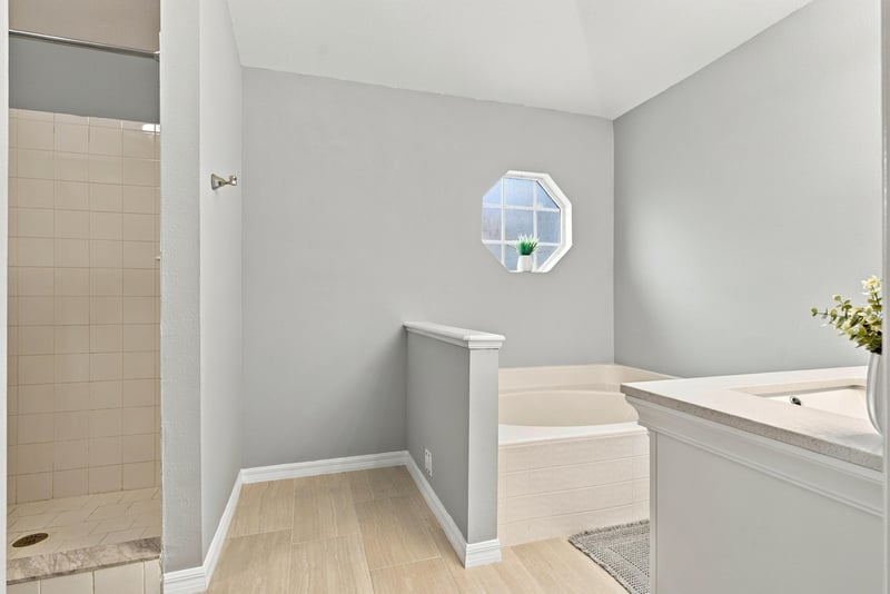 Bathroom with octagon window and tile shower at 11197 Illford Dr