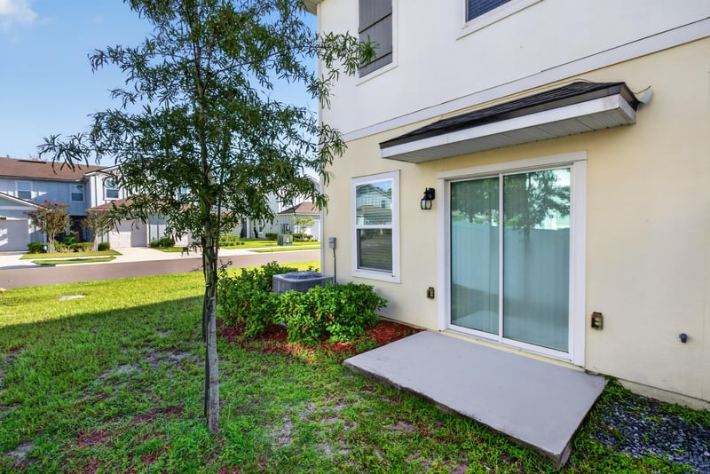Side patio with sliding glass door at 4024 Bay Hawk Ct, Jacksonville, FL