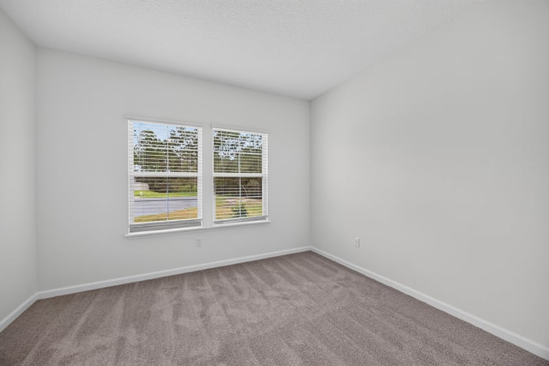 Bedroom with window and carpet flooring at 9905 Ansley Lake Dr, Jacksonville, FL