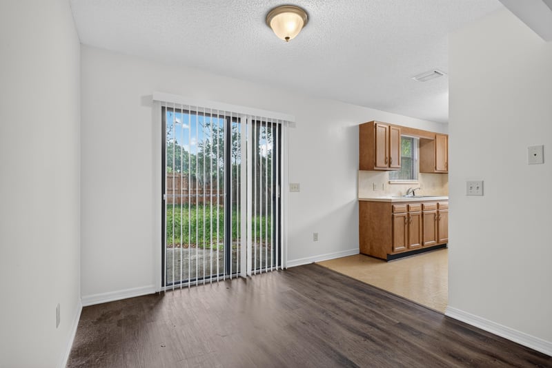 Living room sliding door and wood flooring at 1445 Classic Oak Rd W, Jacksonville, FL